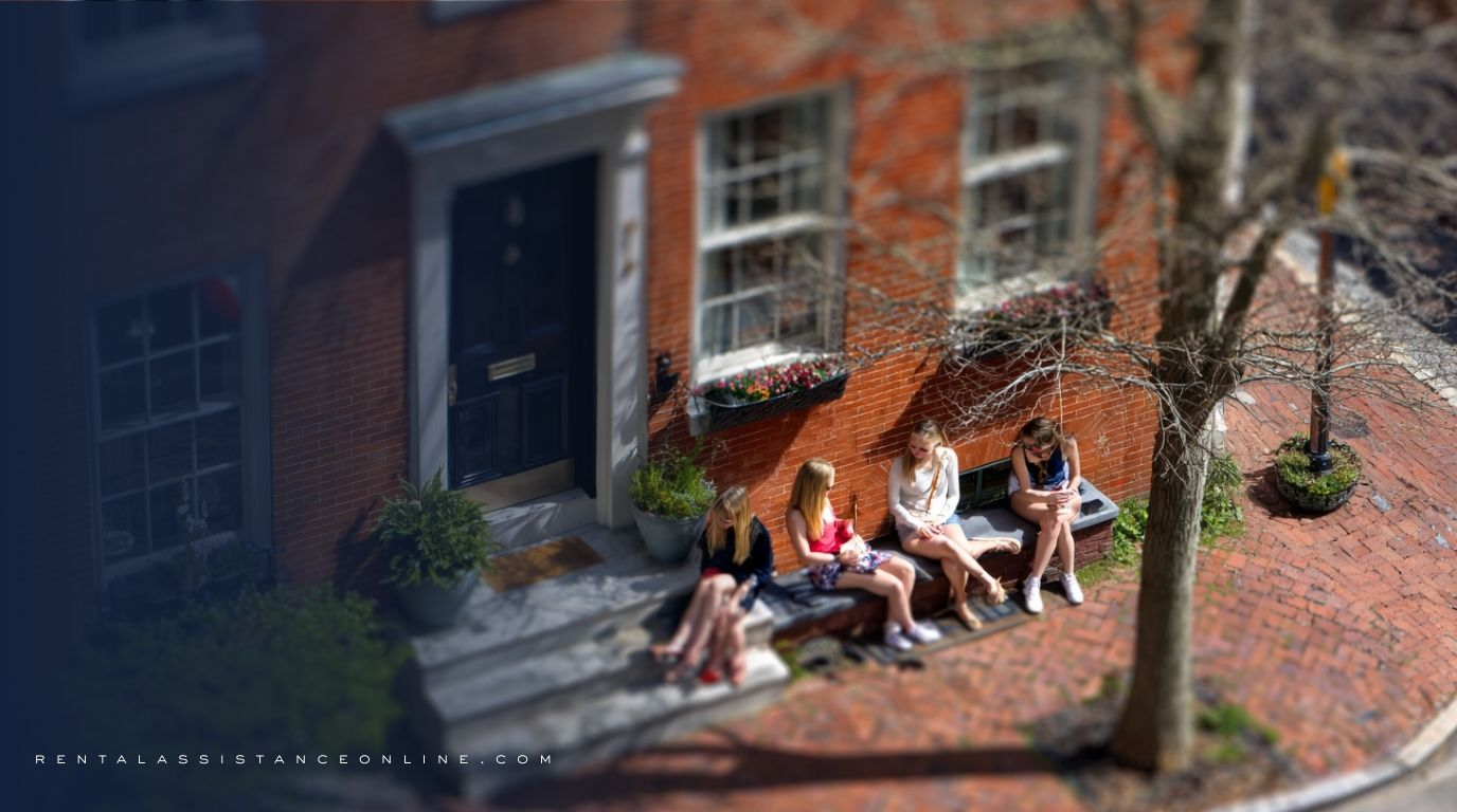 Friends discussing Maryland rental assistance options outside their apartment